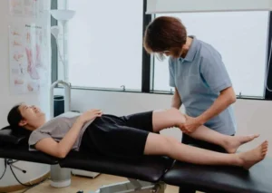 Physiotherapist guiding a patient through a balance and strengthening exercise