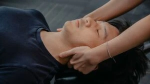 Chiropractor performing a neck adjustment to improve balance