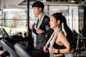 Young healthy people are running on track in gym