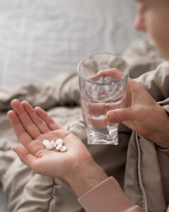Woman with medicines on her hands