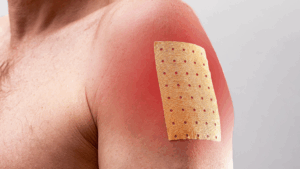 Man with a pain relief patch
