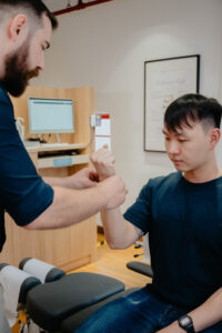 Chiropractor helping a patient with arm pain