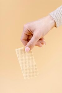 Person holding a pain relief patch
