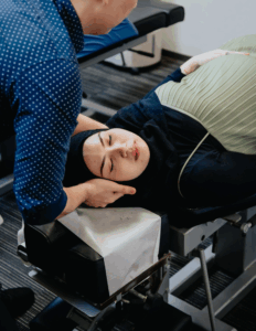 Pregnant woman getting chiropractic adjustment