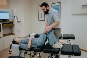 Chiropractor conducting a physical joint assessment to show how chiropractors treat knee pain effectively.