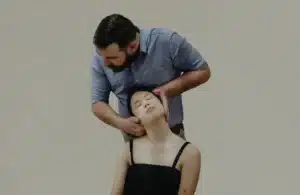 Male practitioner delivering a cervical spine alignment, representative of techniques used by frozen shoulder chiropractors in Singapore.