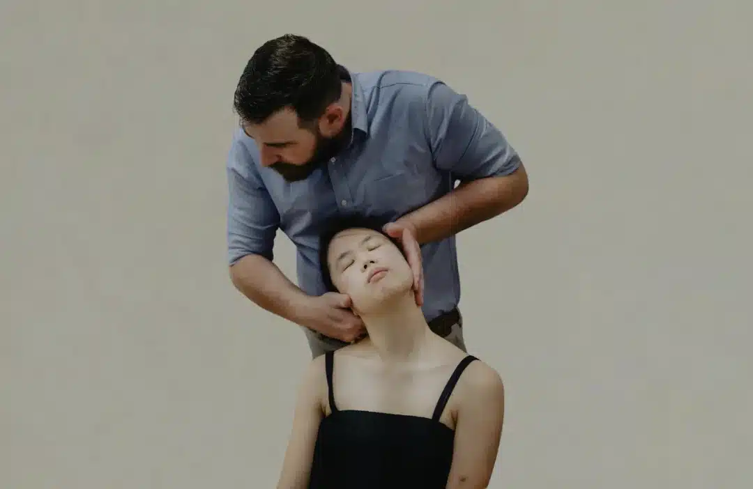 Male practitioner delivering a cervical spine alignment, representative of techniques used by frozen shoulder chiropractors in Singapore.