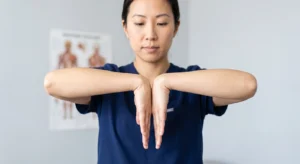 Asian woman performing Phalen's test