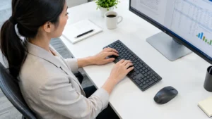 Office worker typing on a keyboard, a common repetitive strain