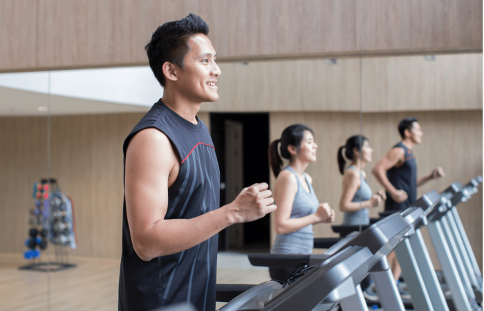 man and woman exercising on treadmill